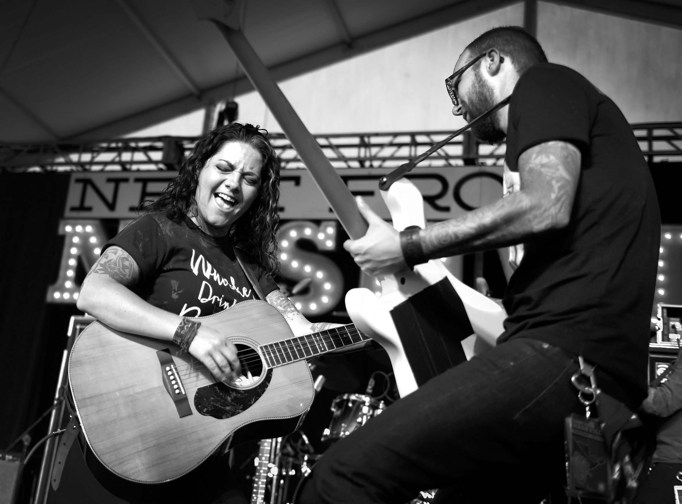 LAS VEGAS, NV - SEPTEMBER 29: (EDITORS NOTE: Image has been converted to black and white.) Recording artist Ashley McBryde (L) and bassist Christian Sancho perform during the Route 91 Harvest country music festival at the Las Vegas Village on September 29, 2017 in Las Vegas, Nevada. (Photo by David Becker/Getty Images)