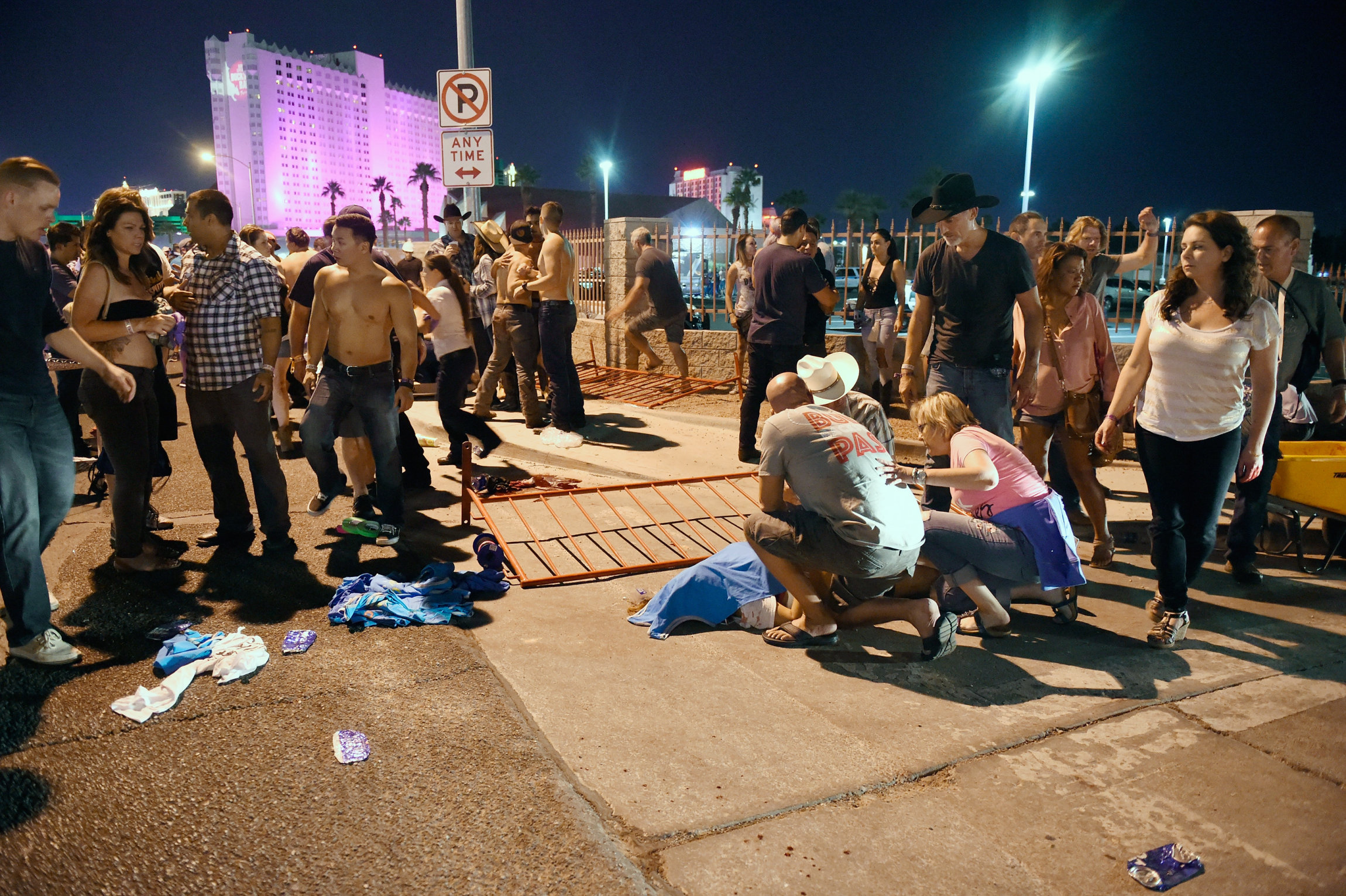 LAS VEGAS, NV - OCTOBER 01: People tend to the wounded outside the Route 91 Harvest Country music festival grounds after an apparent shooting on October 1, 2017 in Las Vegas, Nevada. There are reports of an active shooter around the Mandalay Bay Resort and Casino. (Photo by David Becker/Getty Images)