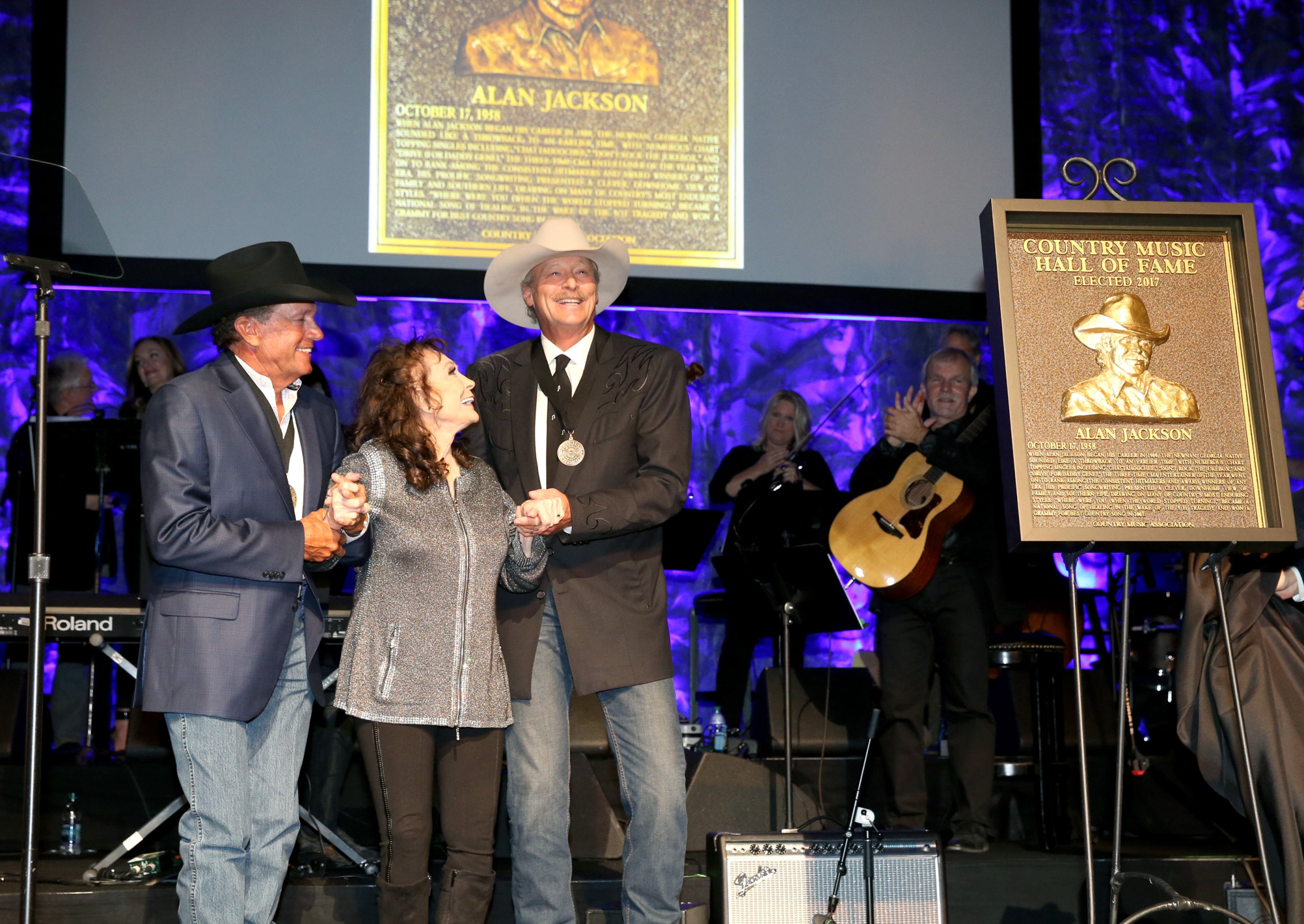 NASHVILLE, TN - OCTOBER 22: (L-R) Musicians George Strait, Loretta Lynn and Alan Jackson onstage at the Country Music Hall of Fame and Museum Medallion Ceremony to celebrate 2017 hall of fame inductees Alan Jackson, Jerry Reed And Don Schlitz at Country Music Hall of Fame and Museum on October 22, 2017 in Nashville, Tennessee. (Photo by Terry Wyatt/Getty Images for Country Music Hall Of Fame & Museum)