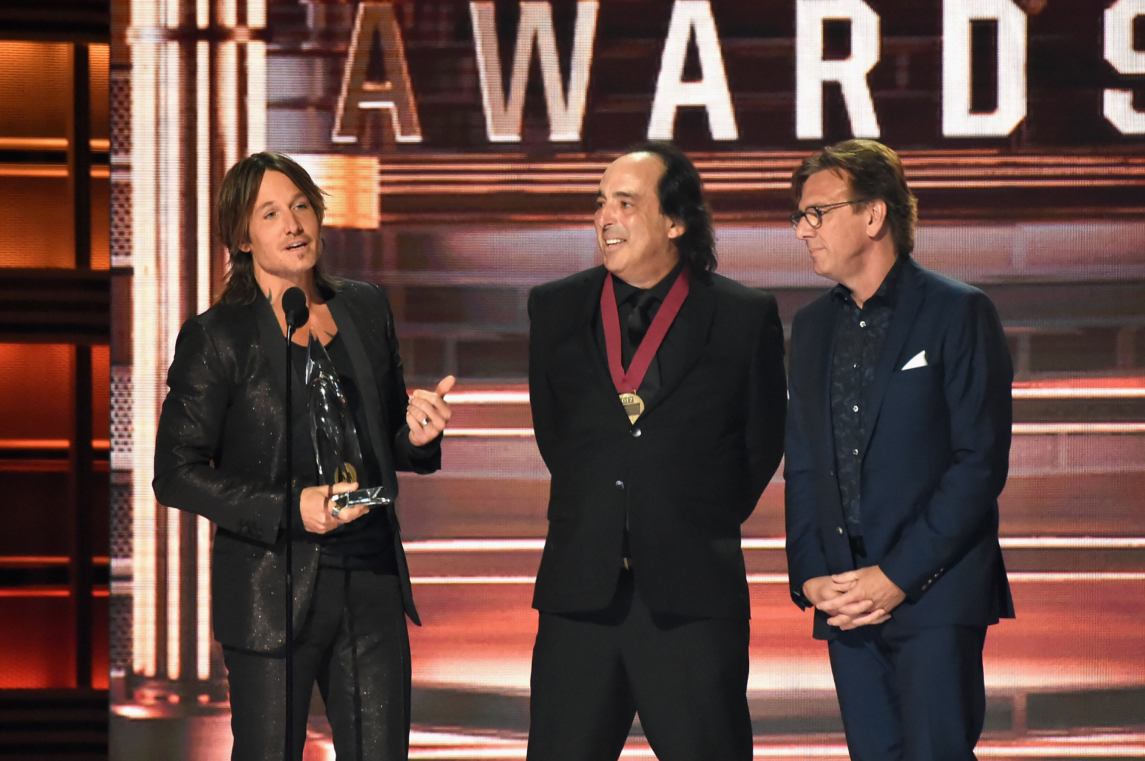 NASHVILLE, TN - NOVEMBER 08: Keith Urban (L) accepts an award onstage at the 51st annual CMA Awards at the Bridgestone Arena on November 8, 2017 in Nashville, Tennessee. (Photo by Rick Diamond/Getty Images)