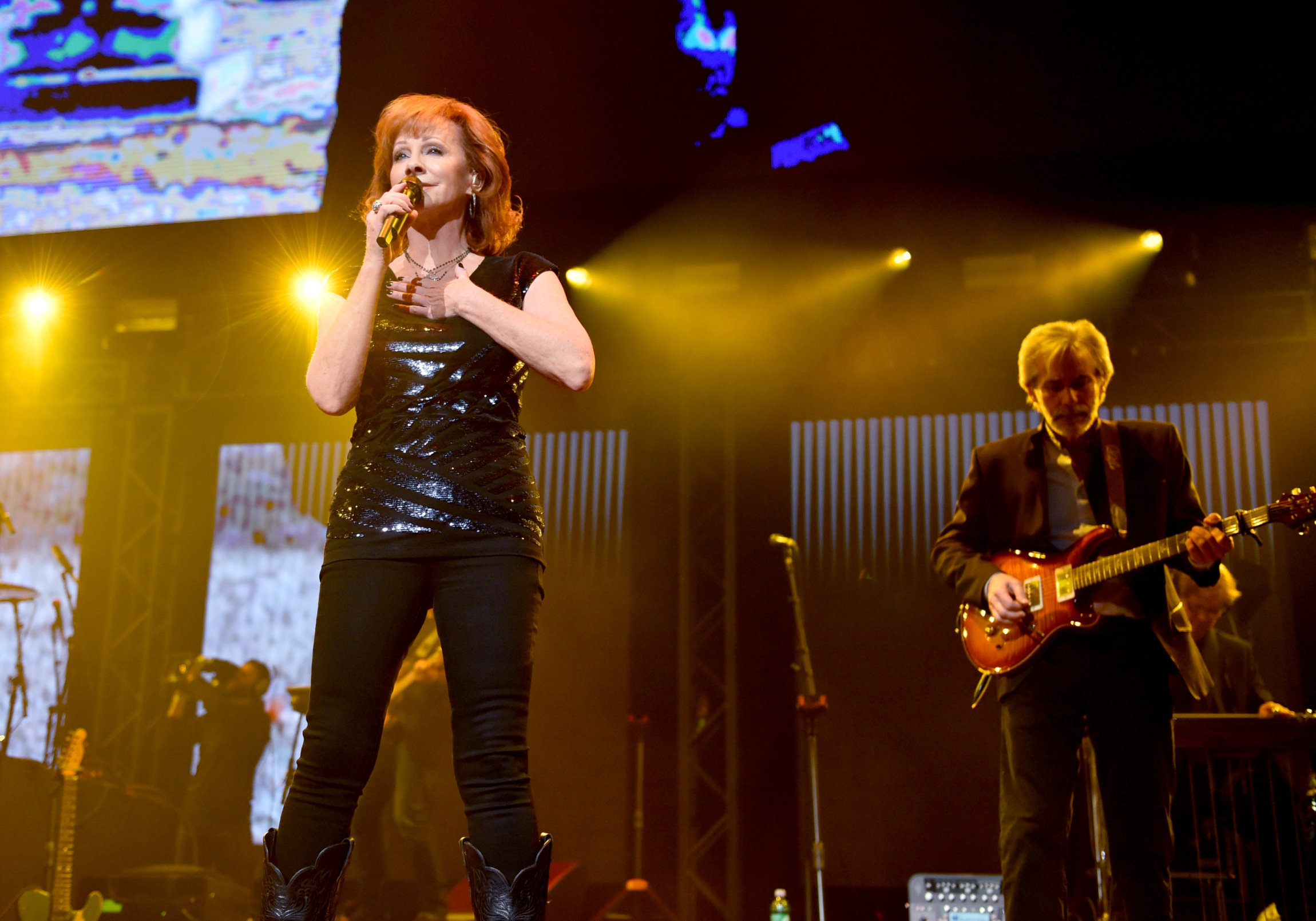 NASHVILLE, TN - NOVEMBER 12: In this handout photo provided by The Country Rising Fund of The Community Foundation of Middle Tennessee, Reba McEntire performs onstage for the Country Rising Benefit Concert at Bridgestone Arena on November 12, 2017 in Nashville, Tennessee. (Photo by John Shearer/Country Rising/Getty Images)