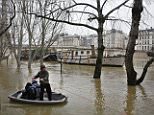 A flooded street lamp is pictured next to the river Seine in Paris. The river has been swollen by recent heavy rainfall 