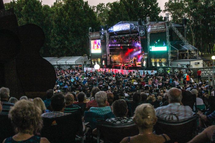 Main stage in Tamworth's Bicentennial park lit up and surrounded by a sea of country fans