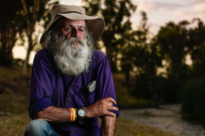 A bush poet with a tobacco stained long white beard and well worn hat 