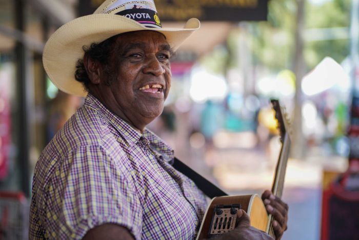 An indigenous man in a hat busking in Peel Street