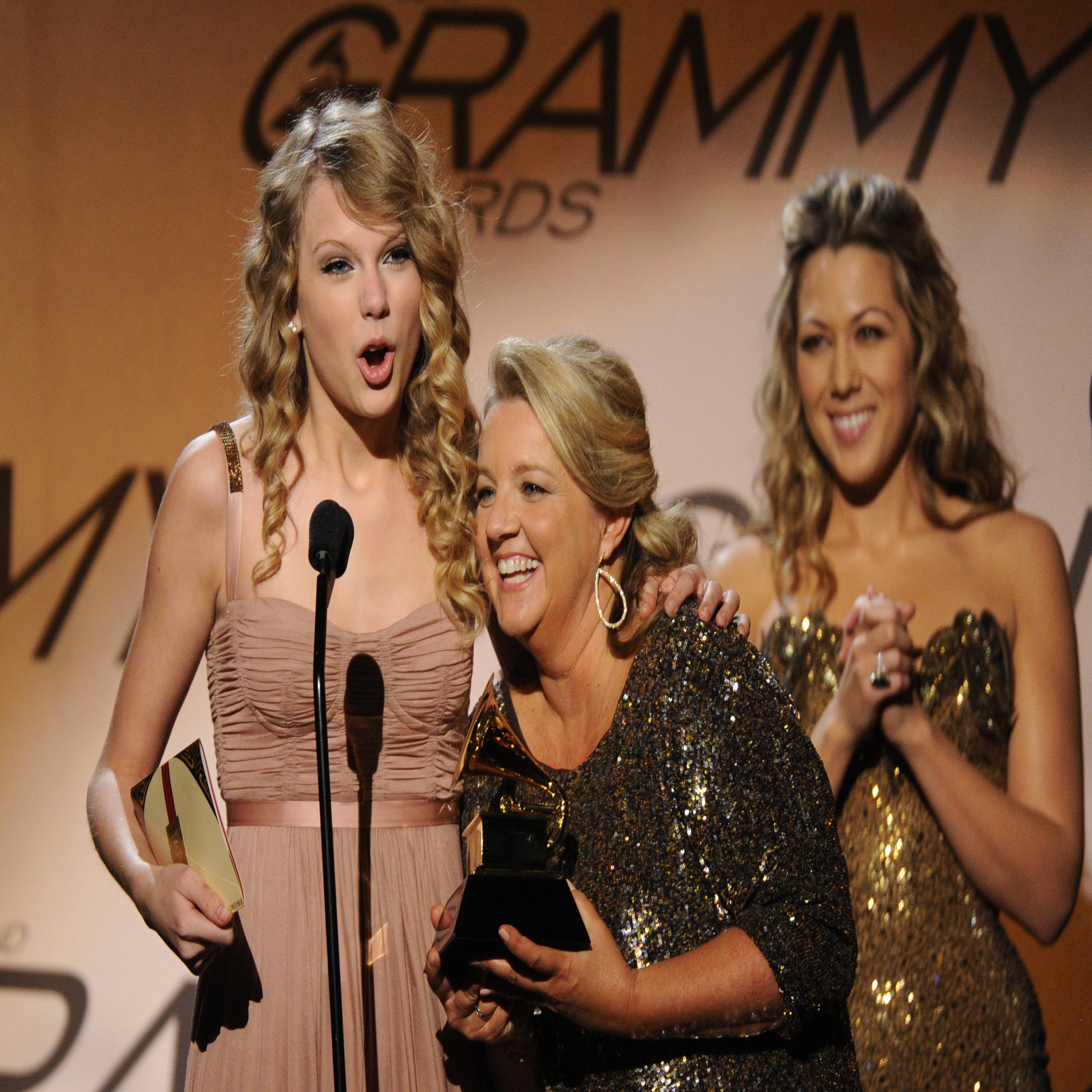 Taylor Swift (L) and songwriter Liz Rose (C) celebrate after winning the Best Country Song award for White Horse during the Pre-Telecast award presentations at the 52nd Grammy Awards in Los Angeles on January 31, 2010. AFP PHOTO/Robyn BECK (Photo credit should read ROBYN BECK/AFP/Getty Images)